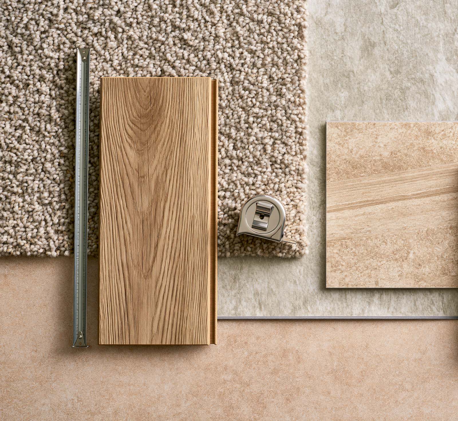 Carpet, wood and stone flooring samples laid out with a steel rule and a tape measure for planning
